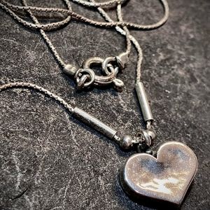 Silpada .925 designer jewelry sterling silver necklace with a heart pendant.